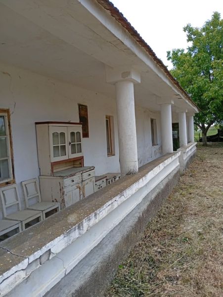 An older family house in Ňárad with a veranda and vintage furniture in front of the house.