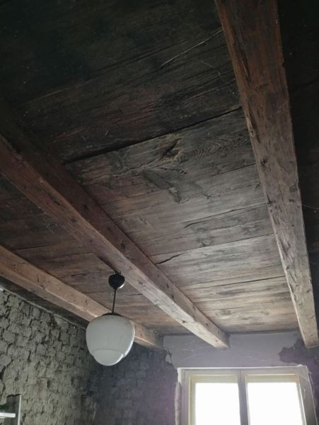 Wooden ceiling and old plaster in the interior of a family house.