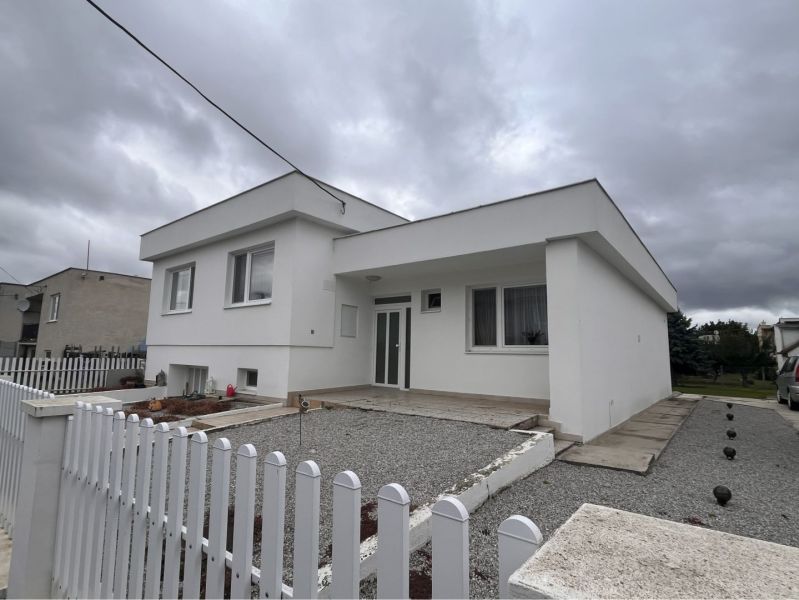 A family house in Trstice with a white facade and a gravel courtyard.