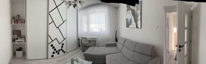 A sofa set with a desk, a cabinet with a geometric pattern in a family house.