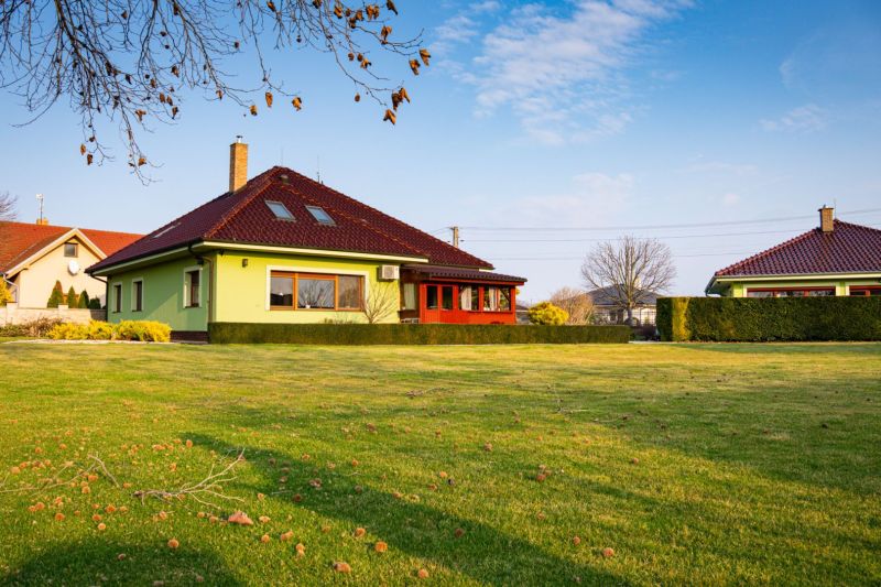A family house in Dolný Bar on Dolný Bar Street with a well-maintained lawn and trees.