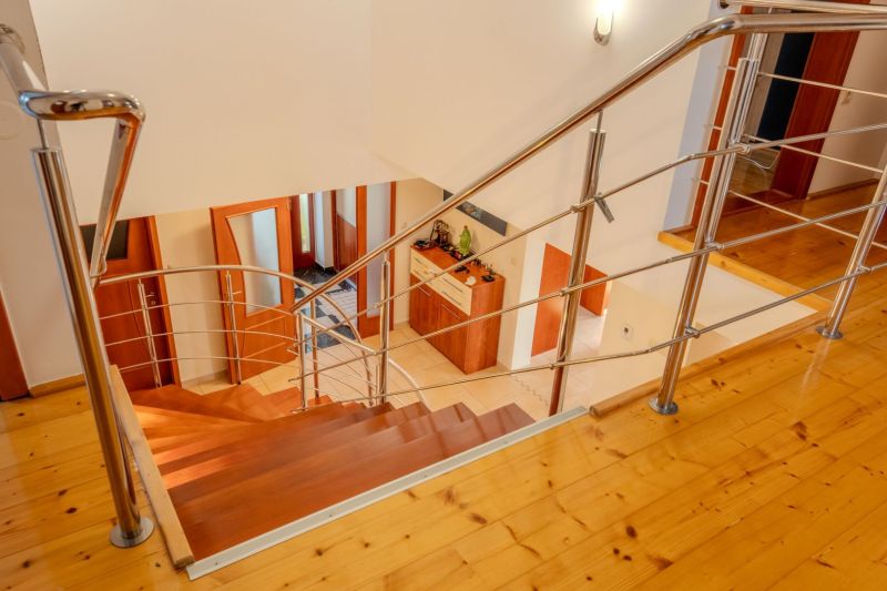 Interior of a family house with a staircase and a wooden decor floor.