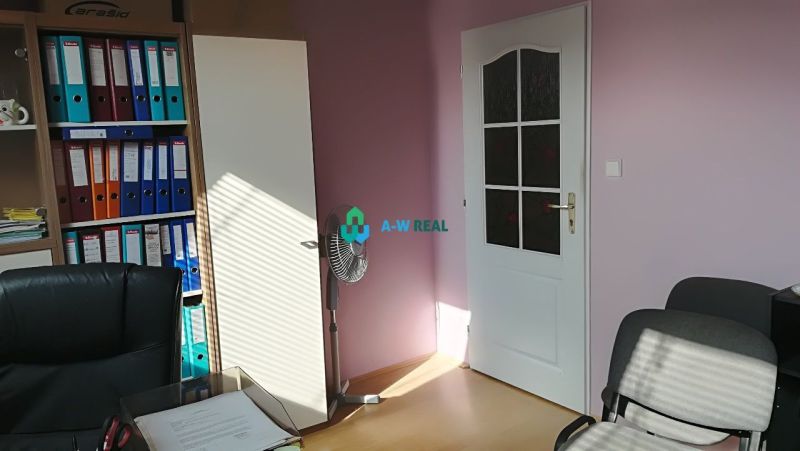Offices with wood-patterned flooring, a document archive, and a fan.