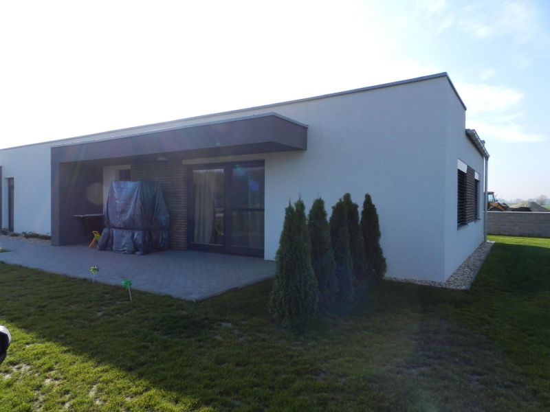 A family house in Dolný Bar with a terrace, yard, and landscaped greenery.