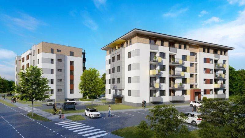 Apartment buildings with parking, greenery, and pedestrians in Dunajská Streda, suitable for 2-room apartments.
