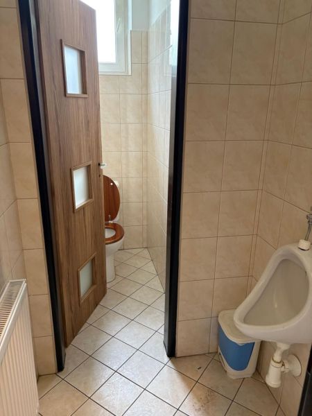 Toilets with wooden interior decor and tiles.