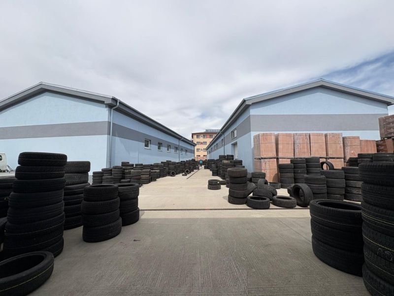 Double rows of tires and construction materials between warehouses and halls in Orechová Potôň.