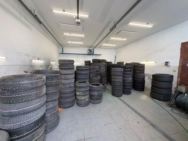 Tires stored in warehouses and halls on a wooden decor floor.