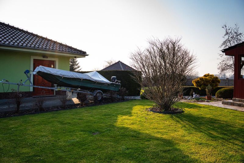 A family house in Dolný Bar with a boat in the garden and a shelter.