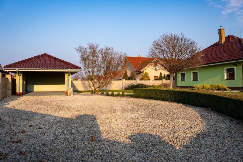 The courtyard of a family house in Dolný Bar with a stone surface and a garage.