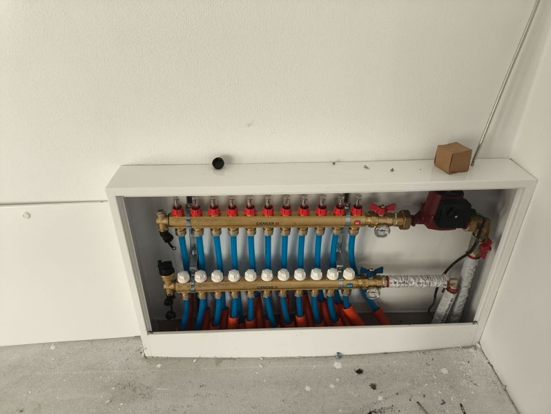 Manifold for underfloor heating in a family house, detailed view of water distribution.