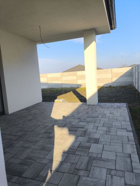 A terrace at a family house in Michal na Ostrove with a tiled floor and a fence.