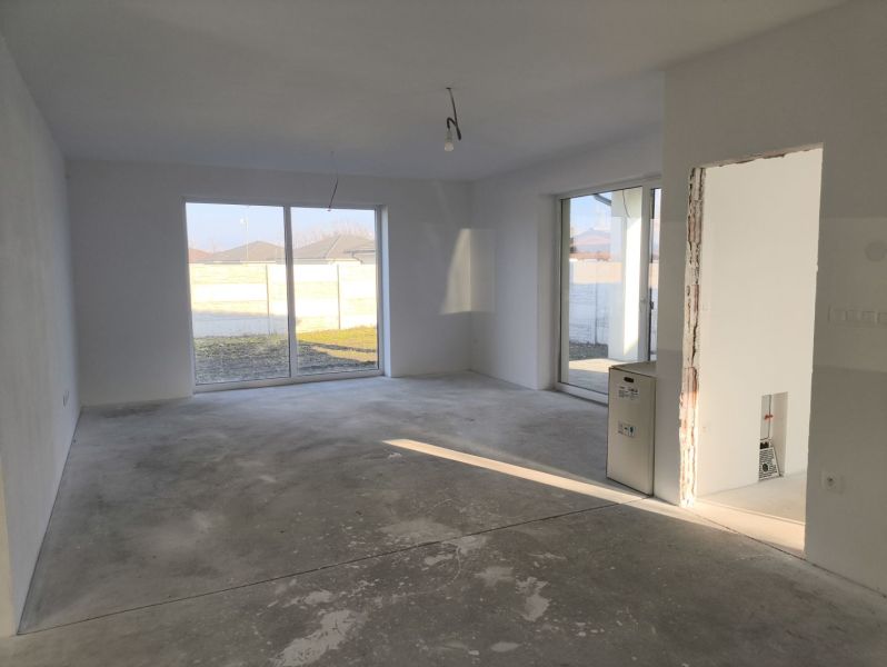 A spacious room with large windows in a family house.