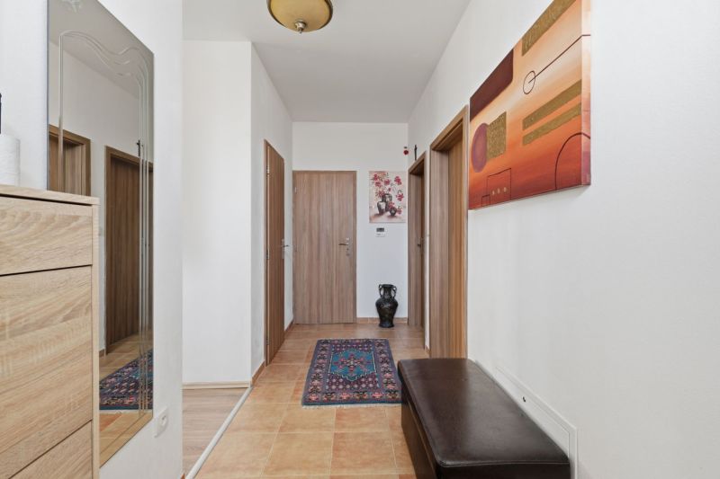 Interior of a family house with a carpet runner, wooden decor, and modern wall art.