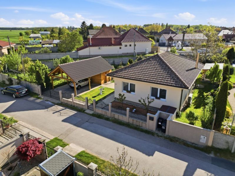A family house in the village of Kostolné Kračany with a garage and a landscaped garden.
