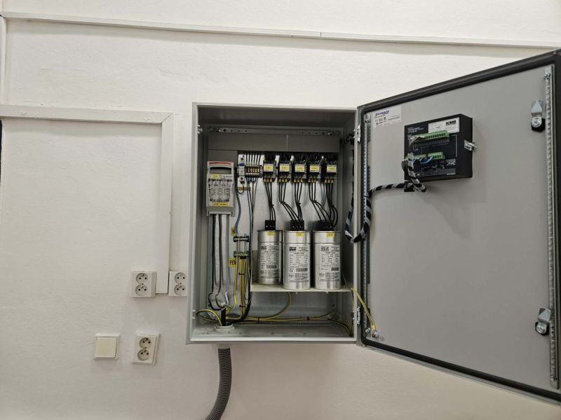 Electrical installation in commercial premises with an open electrical cabinet on the wall.