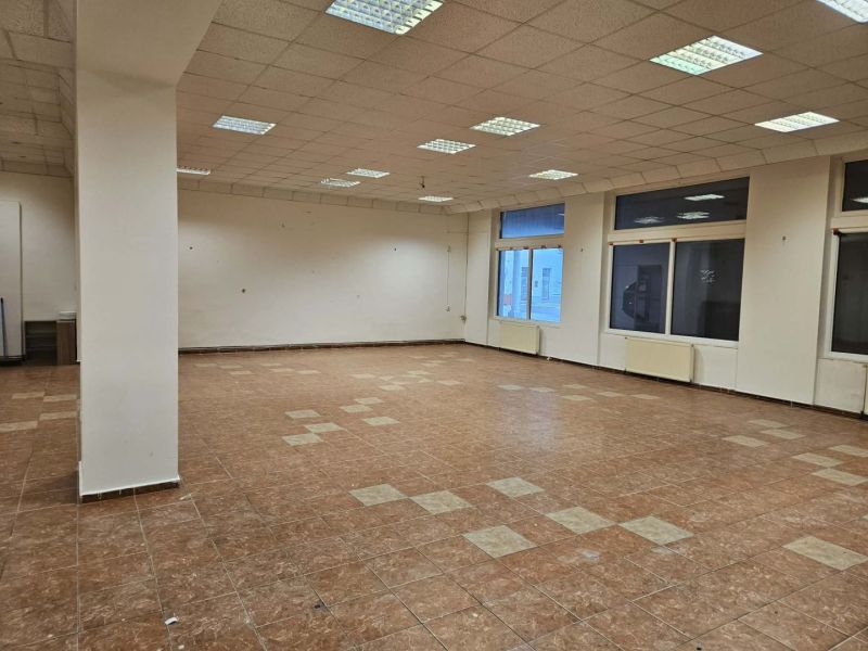 Spacious commercial spaces with tiles and large windows provide plenty of natural light.