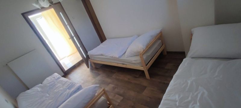 Three beds in a room with a wooden decor floor, Family house.