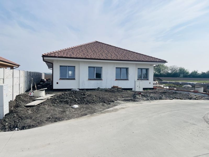 A family house in Michal na Ostrove with a white facade and a pitched roof.