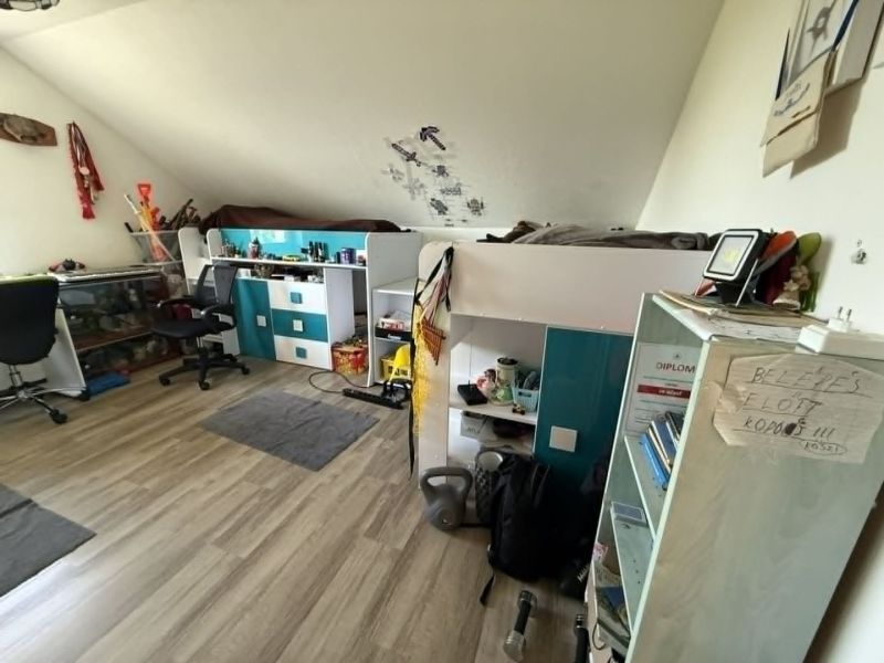 Children's room in a family house with a bunk bed and a floor with a wooden decor.