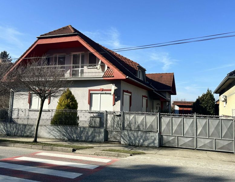 A family house in Dolný Štál with a traditional roof and a landscaped front garden.