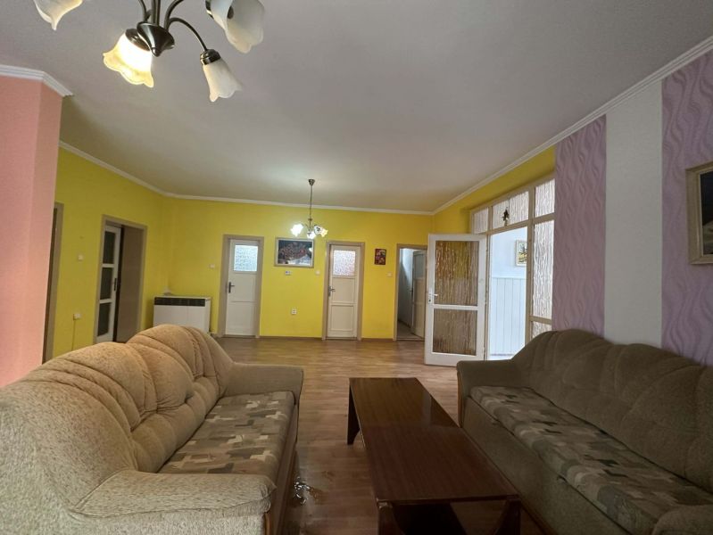 Living room in a family house with comfortable sofas and a wooden decor floor.