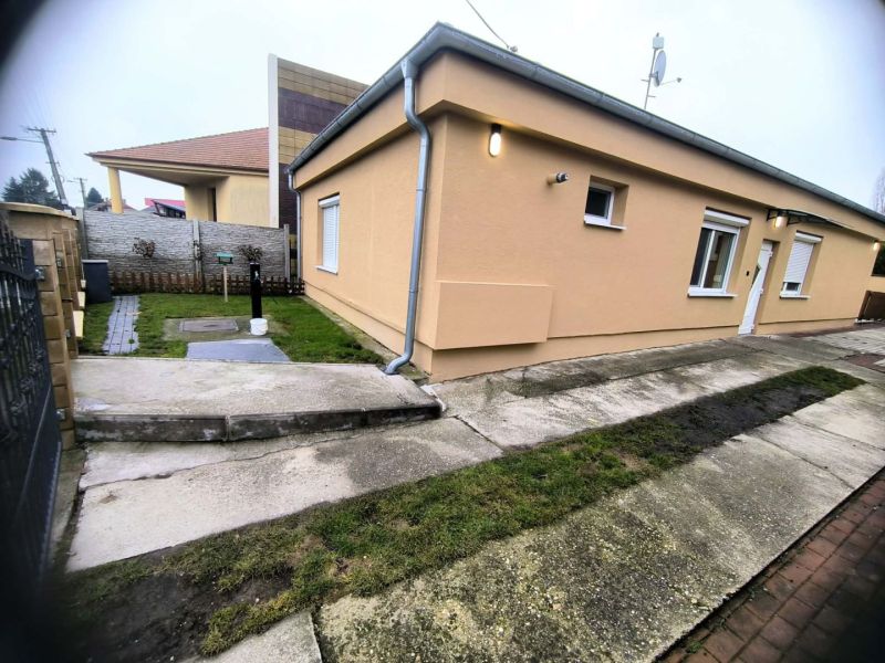 A family house in Ohrady with an outdoor courtyard, walkway, and insulated facade.