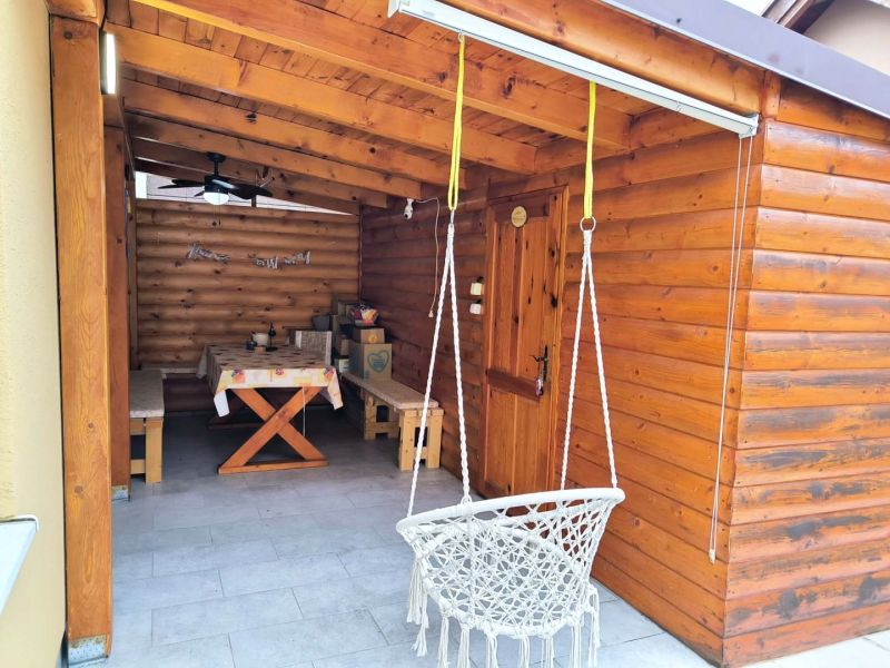 The terrace of a family house in Ohrady with wooden cladding and a swing.