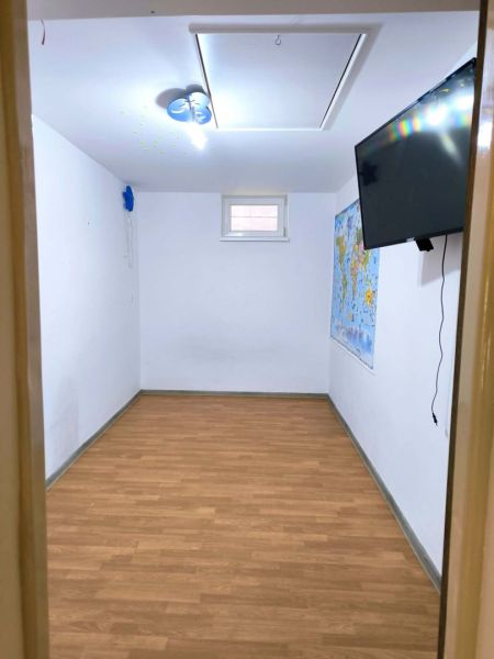 A room in a family house with a map and a wooden decor floor.