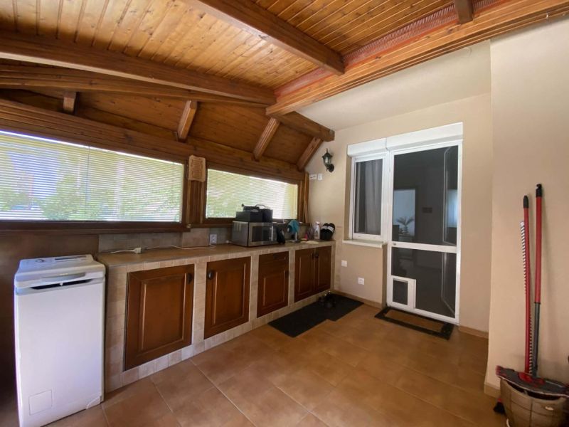 Interior of a 3-room apartment with a kitchen, wooden ceiling, and floor with a wooden decor.