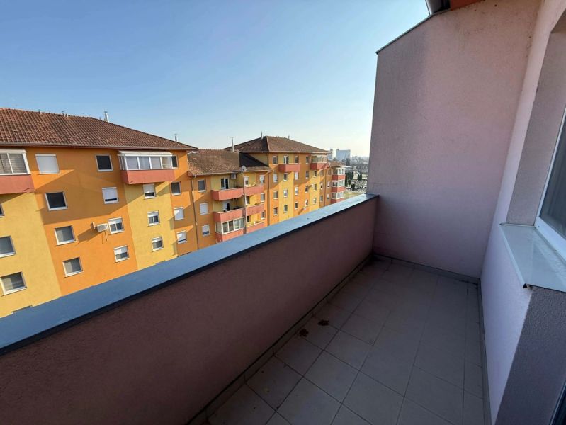 A balcony with a view of colorful buildings in Dunajská Streda, suitable for a 3-room apartment.