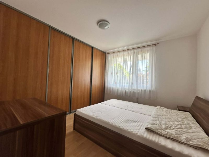 A bedroom in a 3-room apartment with a large wardrobe and a floor with a wooden decor.