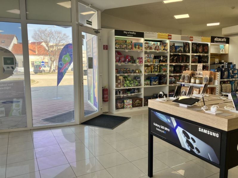 Retail spaces with electronics and toys, wooden decor flooring, light from the exterior.