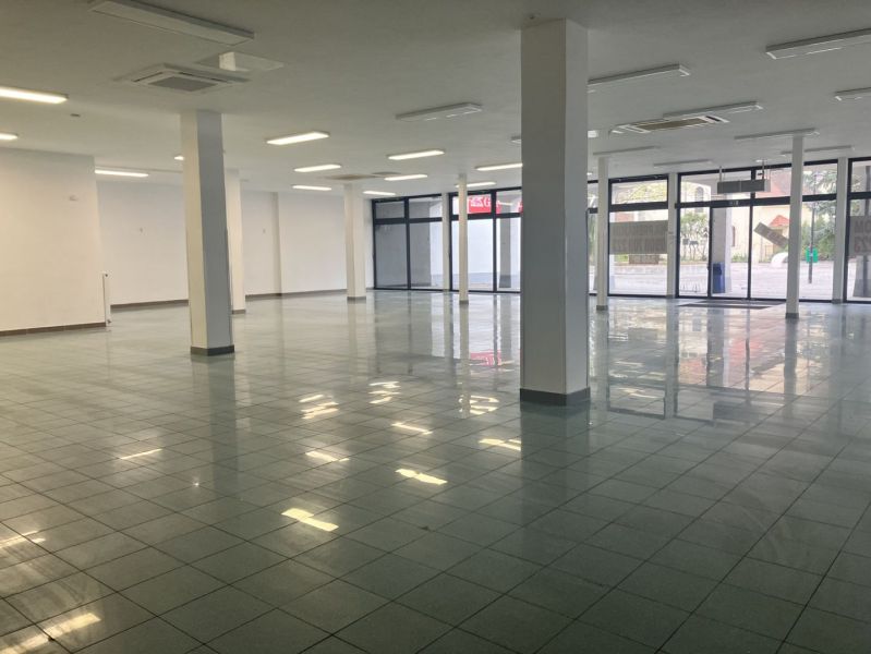 Spacious commercial spaces with glass doors and tiles.
