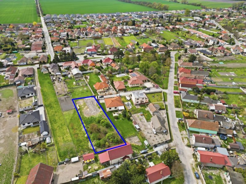 Aerial view of a plot suitable for living in Horná Potôň, surrounded by houses and gardens.