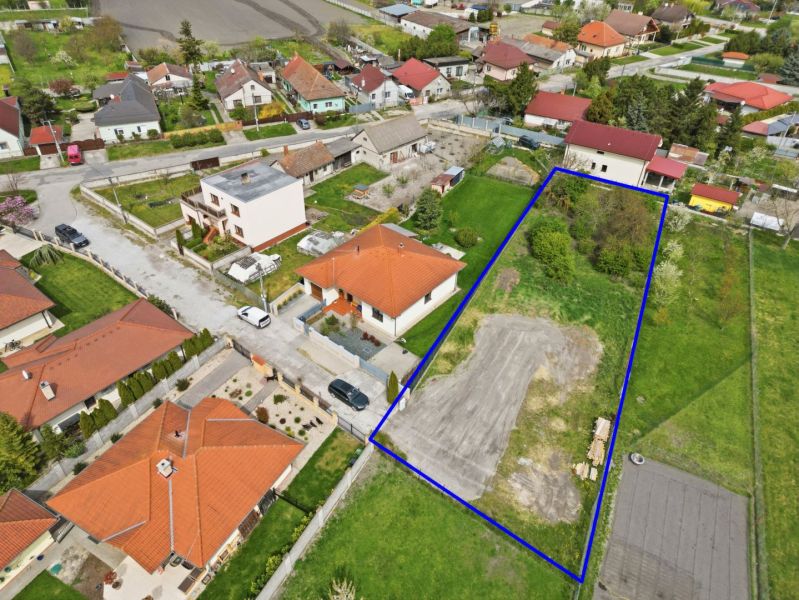 A plot for residential use in Horná Potôň surrounded by houses and greenery.