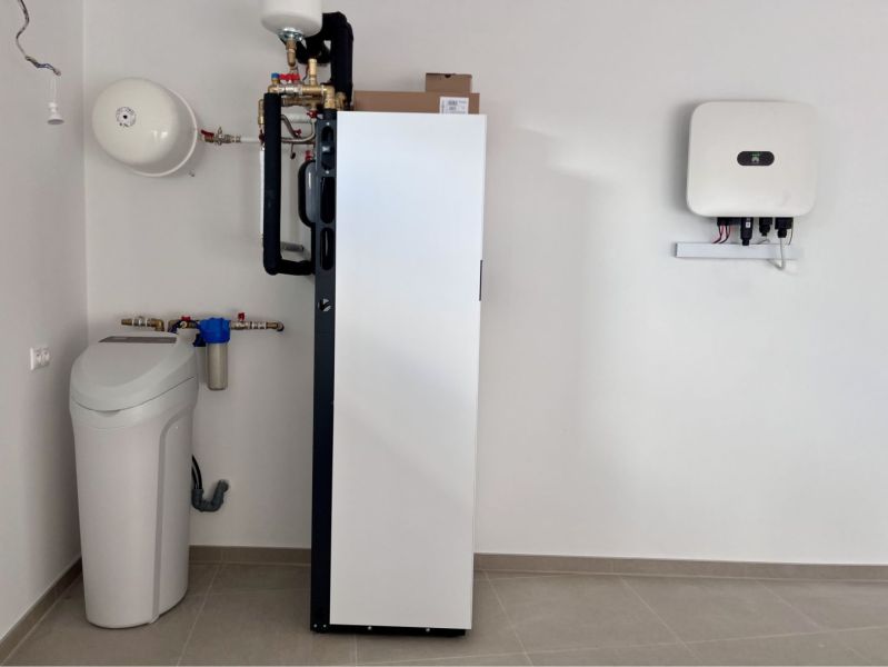 Technical room of a family house with water treatment equipment and a heat pump.