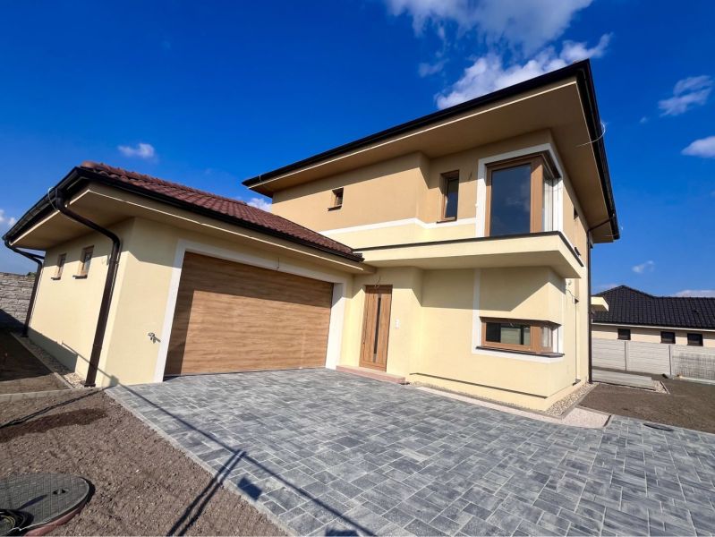 Family house on GARDENTOWN street in Dunajská Streda with garage doors and paving.