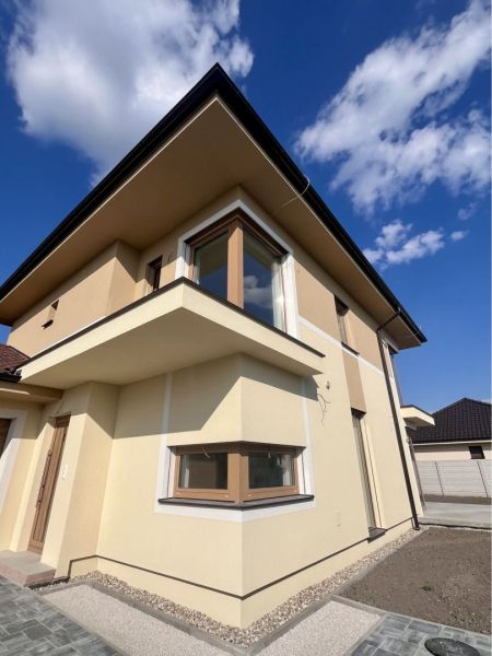 Family house on GARDENTOWN Street in Dunajská Streda with a beige facade and glass windows.