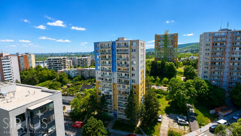 View of residential buildings and green areas in Bratislava on Sadmelijská Street.