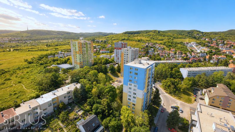 Aerial view of apartment buildings on Sadmelijská Street in Bratislava - Rača, surrounded by greenery.