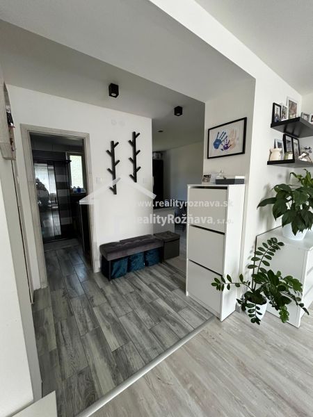 Interior of a 3-room apartment with a wooden decor floor and minimalist decorations.