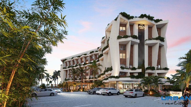 Residential complex in Paje, Unguja South, surrounded by greenery, parking in front of the building.