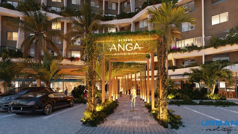 Apartment construction in Paje, Unguja South, illuminated entrance gates surrounded by greenery.
