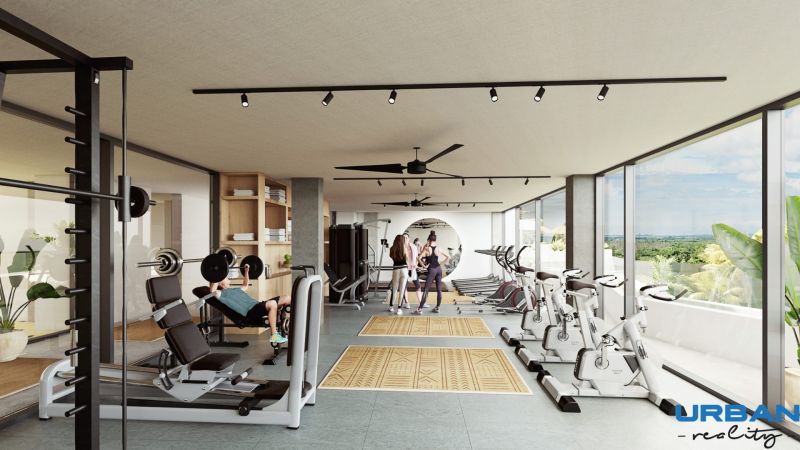 Gym with cardio machines, dumbbells, and large windows, floor with wood decor.