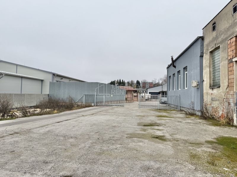 Industrial yard with buildings and a fence in the exterior of Žilina, offices.