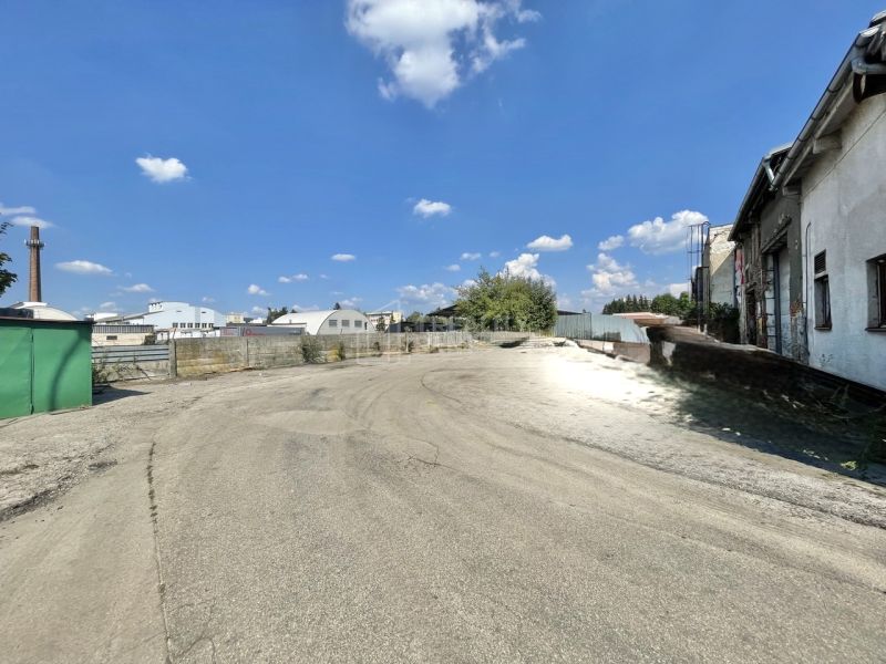 Paved area at the offices in Žilina with a view of the surrounding buildings and the sky.