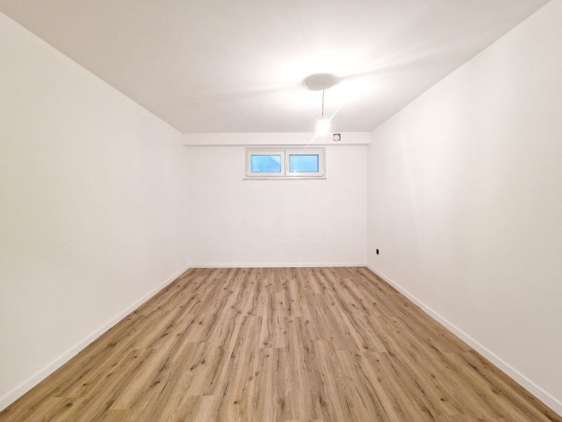 A spacious room in a 3-room apartment with a wooden decor floor.