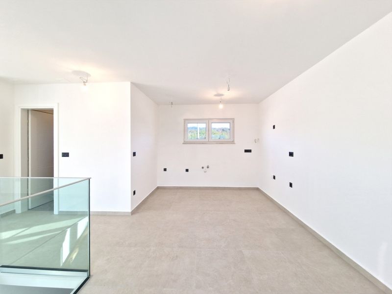 A spacious room in a 3-room apartment with a large window and light-colored walls.