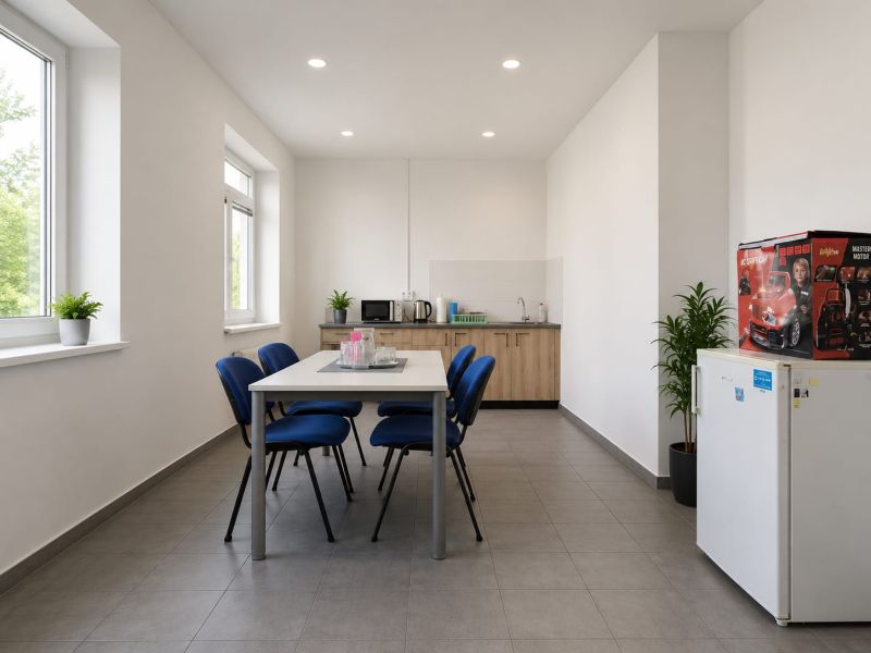 Dining room in warehouses and halls with a kitchenette, table and chairs, bright environment.